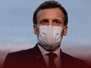 Macron says France will have to fight with COVI-19 'at least until next summer'